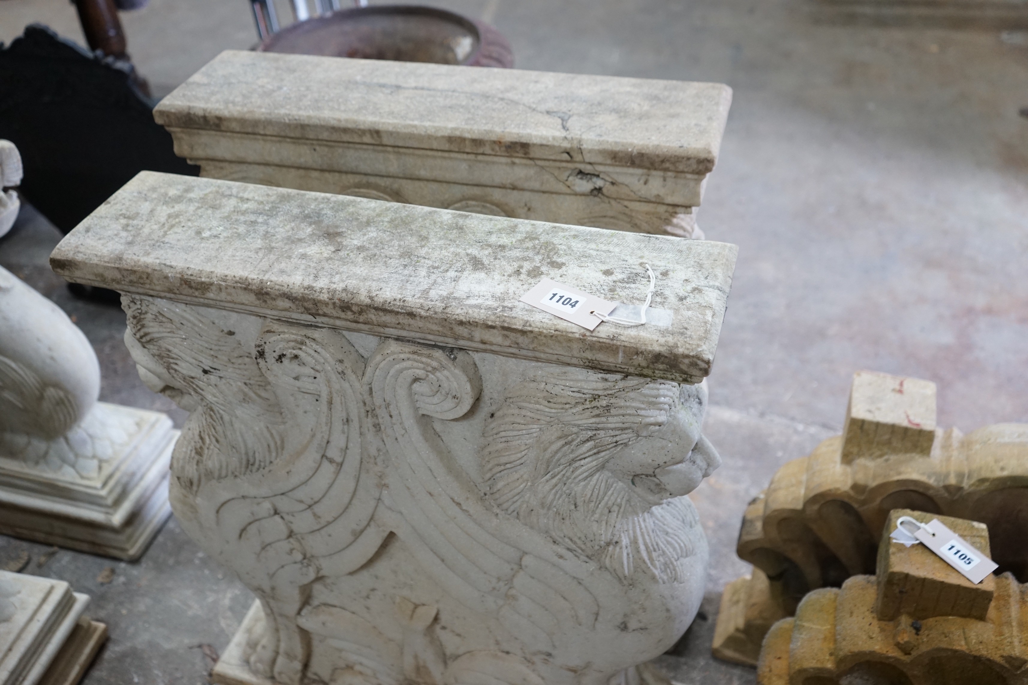 A pair of carved stone serpent table supports, width 75cm, height 78cm